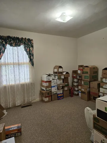 a bathroom with a granite countertop toilet sink and mirror