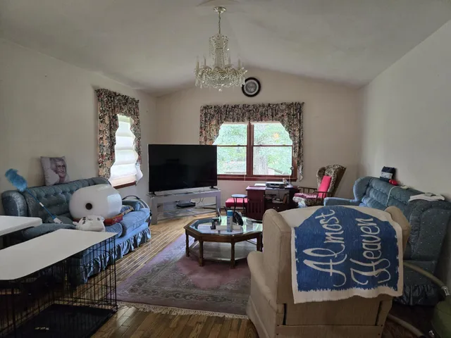a living room with furniture fireplace and a large window