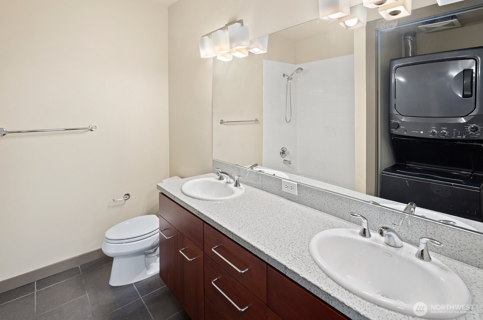 655 Crockett Street, Unit A305 Seattle, WA 98109 - Photo 16 of 23 a bathroom with a double vanity sink toilet and a mirror