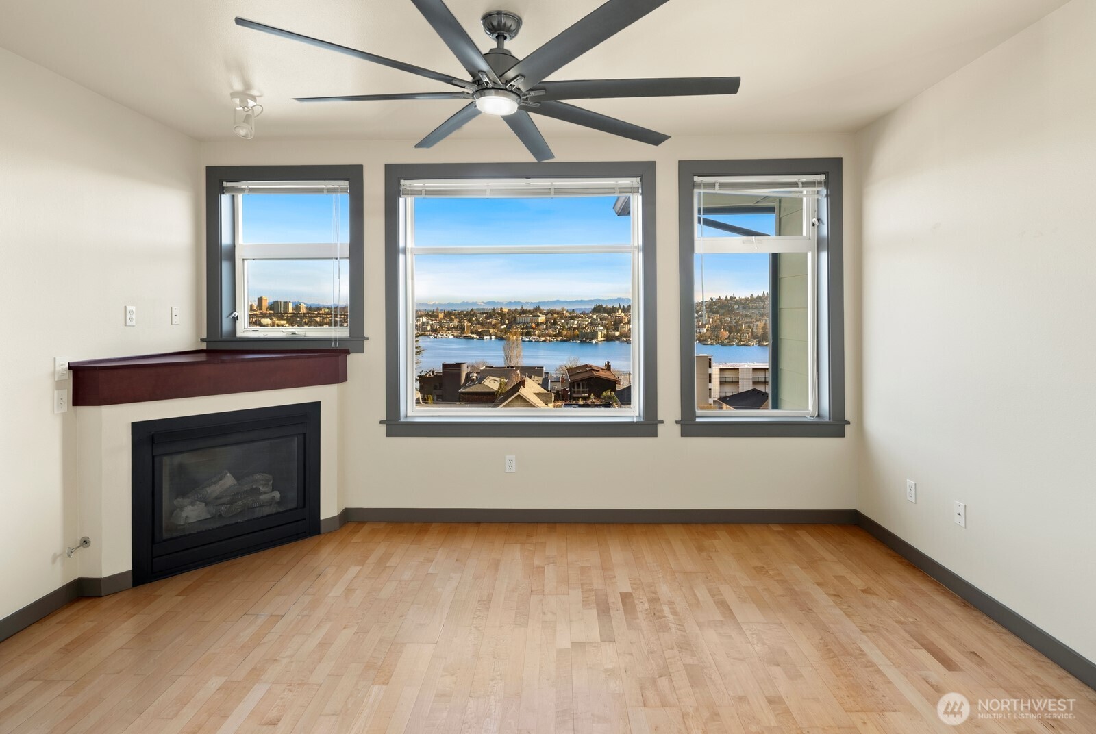 655 Crockett Street, Unit A305 Seattle, WA 98109 - Photo 6 of 23 an empty room with wooden floor fireplace and windows