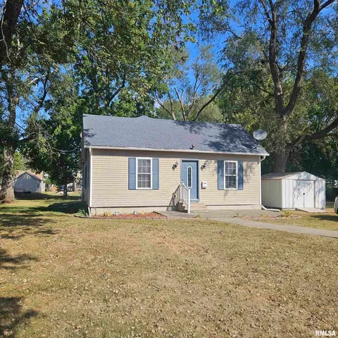 a house that has a tree in front of the house