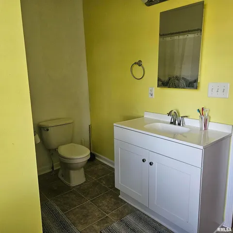 a bathroom with a sink mirror and toilet