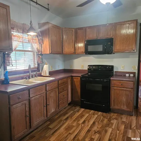 a kitchen with a sink stove and microwave