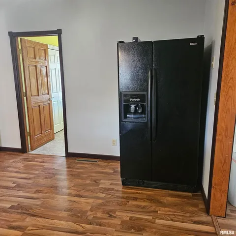 an empty room with wooden floor and closet