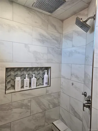 a bathroom with a mirror and a shower