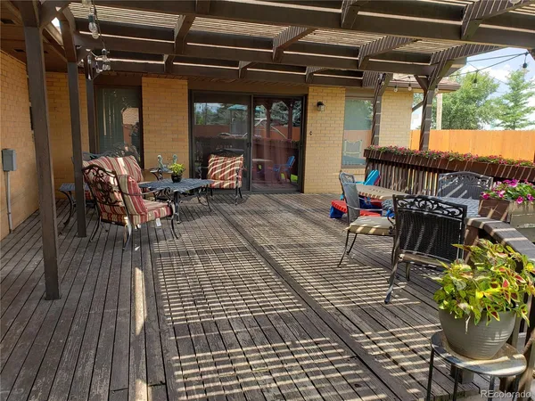 a view of a house with a yard and deck
