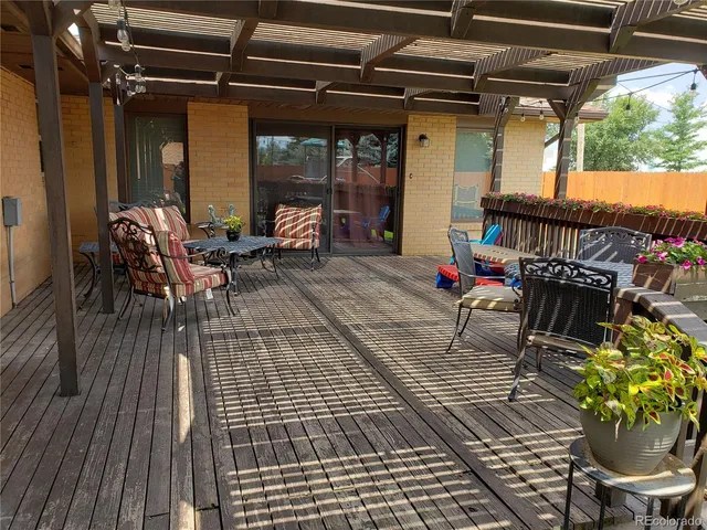 a view of a house with a yard and deck