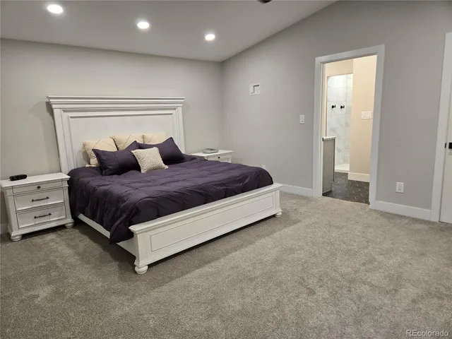 a bedroom with a bed and a night stand