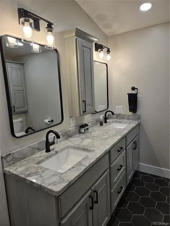 a bathroom with double vanity sinks and a mirror