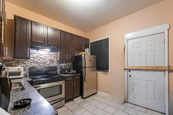 a kitchen with granite countertop stainless steel appliances and wooden cabinets