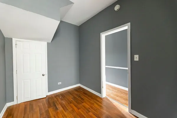 a view of a room with wooden floor