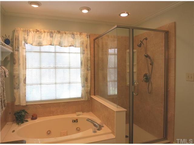 2613 Bembridge Drive Raleigh, NC 27613 - Photo 18 of 25 Another view of the updated Master Bath shows the whirlpool tub & separate tile-look shower (no grout to clean!). Master Bath/Spa