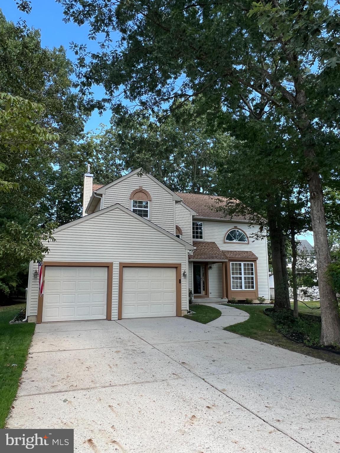 a house that has a tree in front of it
