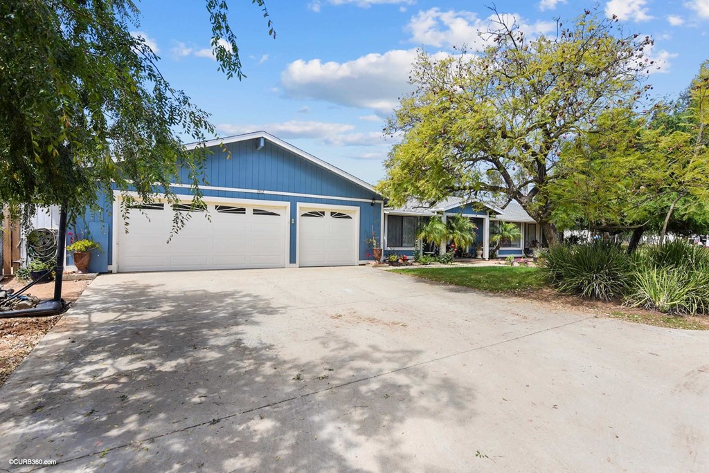 13912 Maude Road Valley Center, CA 92082 - Photo 1 of 1 a front view of a house with a yard and garage