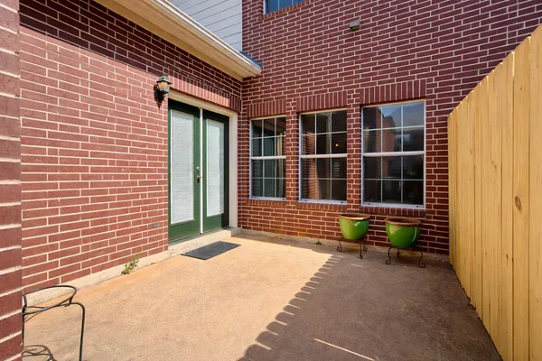a view of a brick house with an outdoor space