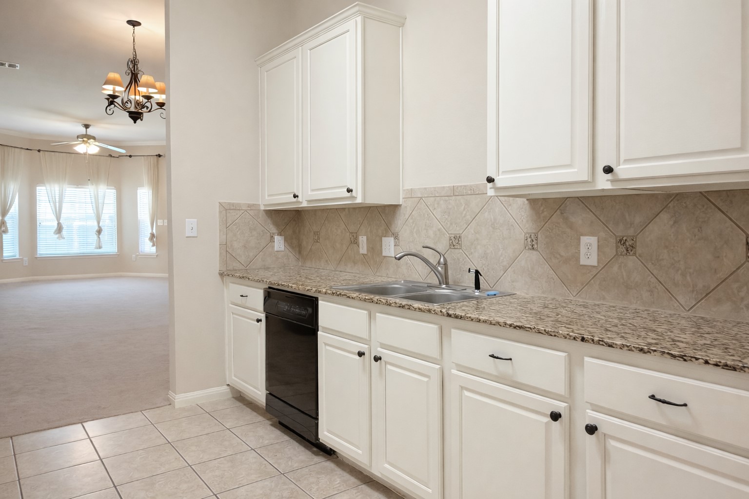 5515 Davis Lane, Unit 82 Austin, TX 78749 - Photo 7 of 20 a kitchen with granite countertop white cabinets and stainless steel appliances