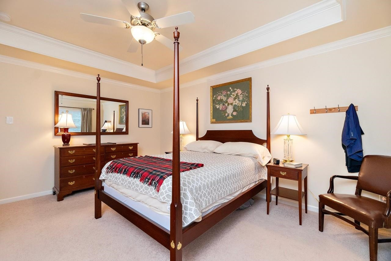 2033 Weston Green Loop Cary, NC 27513 - Photo 12 of 24 a bedroom with a bed and a dresser