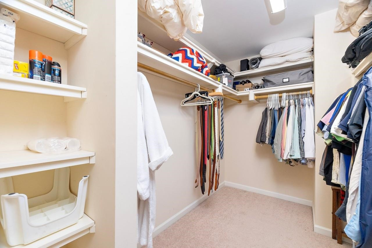 2033 Weston Green Loop Cary, NC 27513 - Photo 13 of 24 a view of walk in closet with clothes and shoes