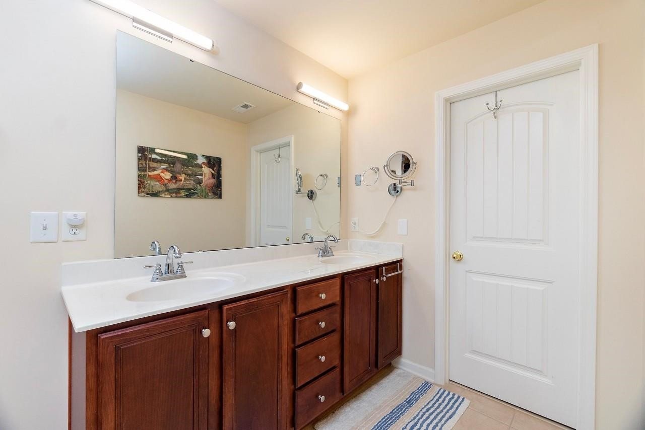 2033 Weston Green Loop Cary, NC 27513 - Photo 14 of 24 a bathroom with a double vanity sink a and mirror