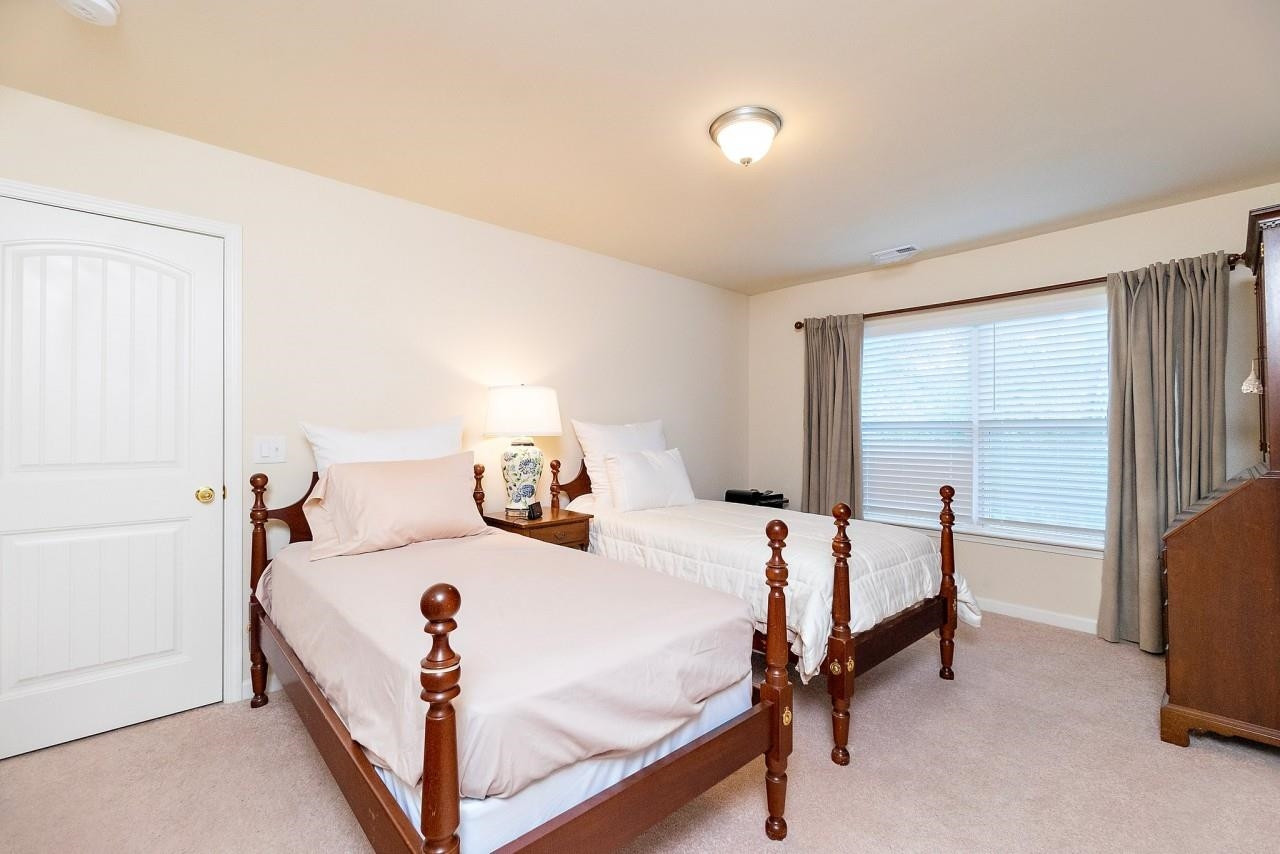 2033 Weston Green Loop Cary, NC 27513 - Photo 16 of 24 a bedroom with bed and a window
