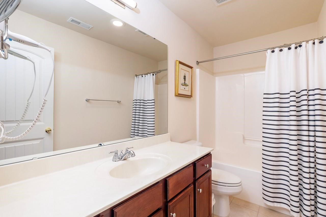 2033 Weston Green Loop Cary, NC 27513 - Photo 17 of 24 a bathroom with a sink toilet and shower