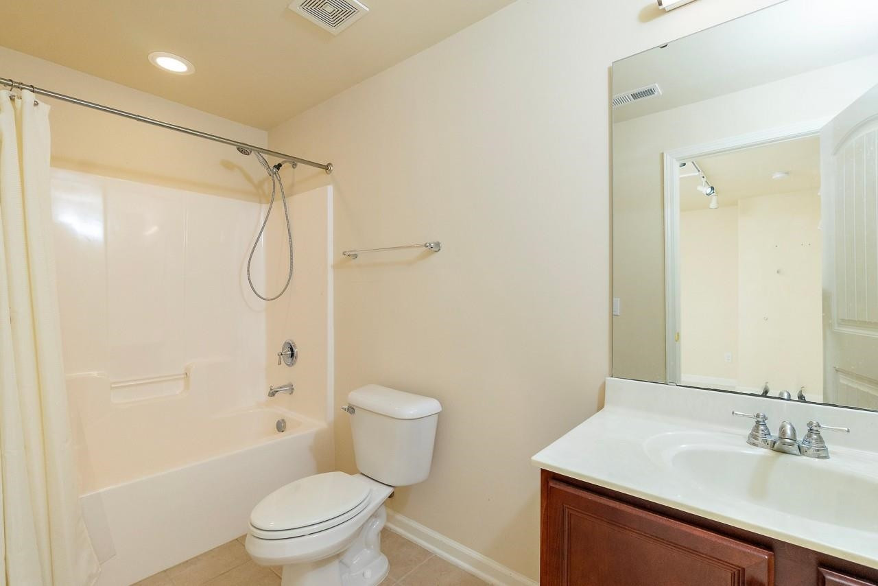 2033 Weston Green Loop Cary, NC 27513 - Photo 22 of 24 a bathroom with a sink toilet and shower