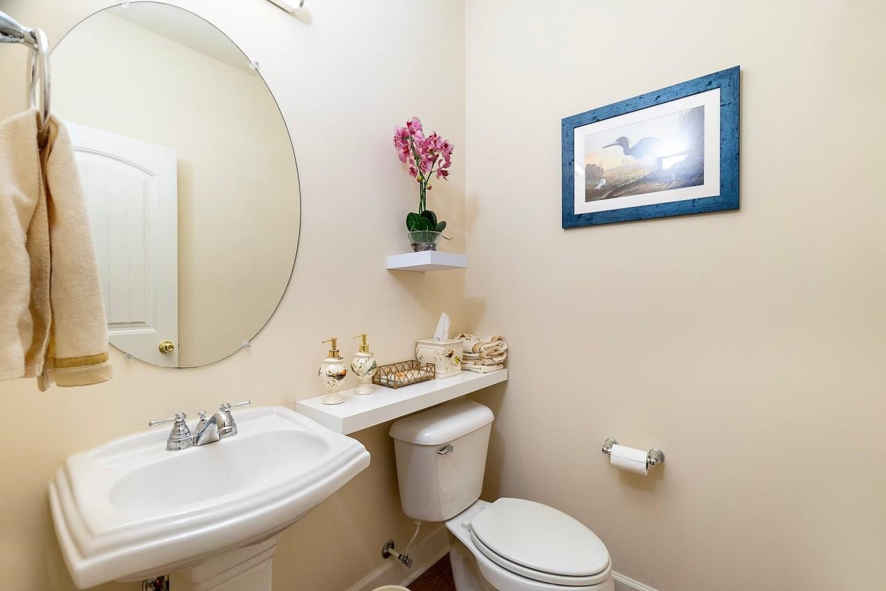 2033 Weston Green Loop Cary, NC 27513 - Photo 4 of 24 a bathroom with a toilet sink and mirror