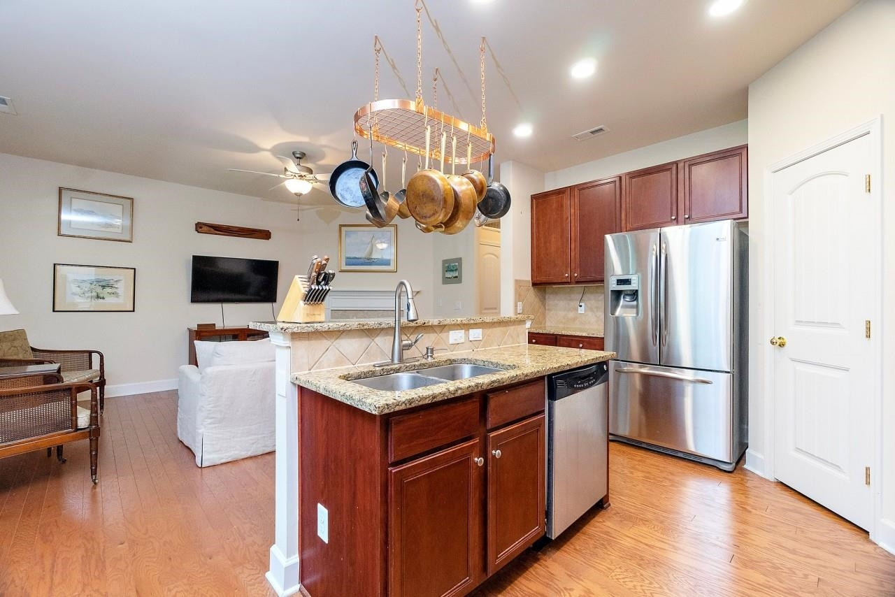 2033 Weston Green Loop Cary, NC 27513 - Photo 6 of 24 a kitchen with stainless steel appliances granite countertop a refrigerator a stove a sink dishwasher and a refrigerator with wooden floor