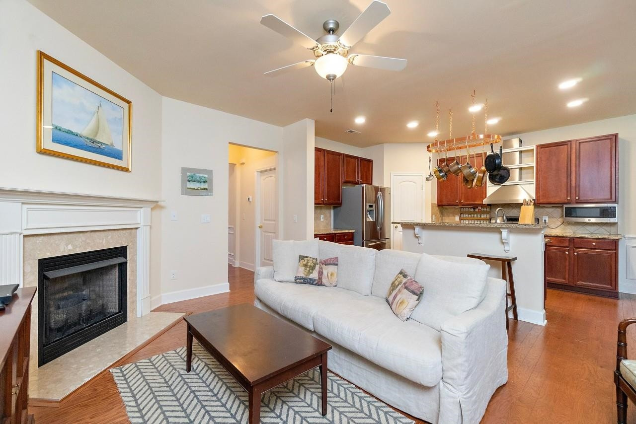 2033 Weston Green Loop Cary, NC 27513 - Photo 7 of 24 a living room with furniture kitchen view and a fireplace