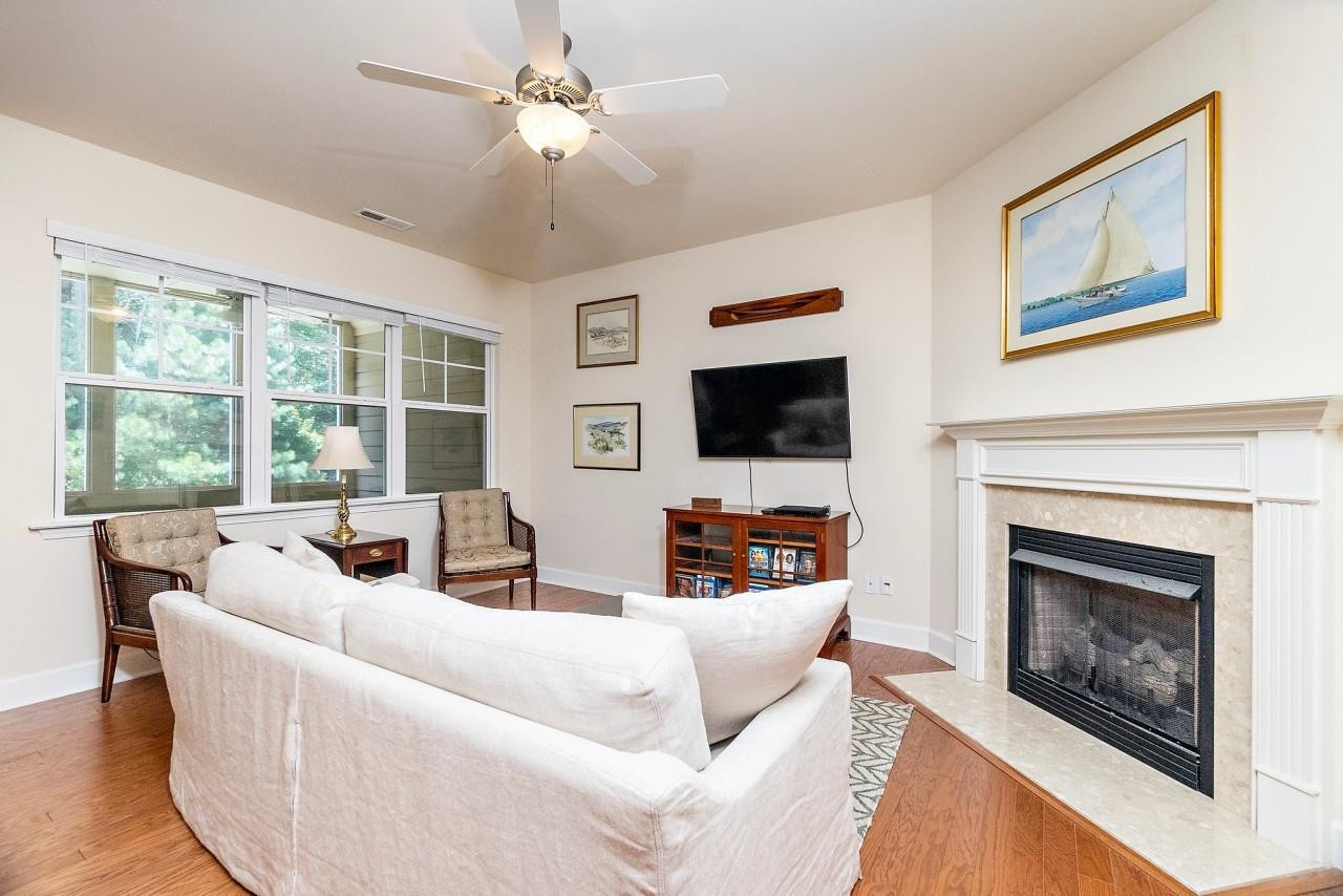 2033 Weston Green Loop Cary, NC 27513 - Photo 8 of 24 a living room with furniture a fireplace and a flat screen tv
