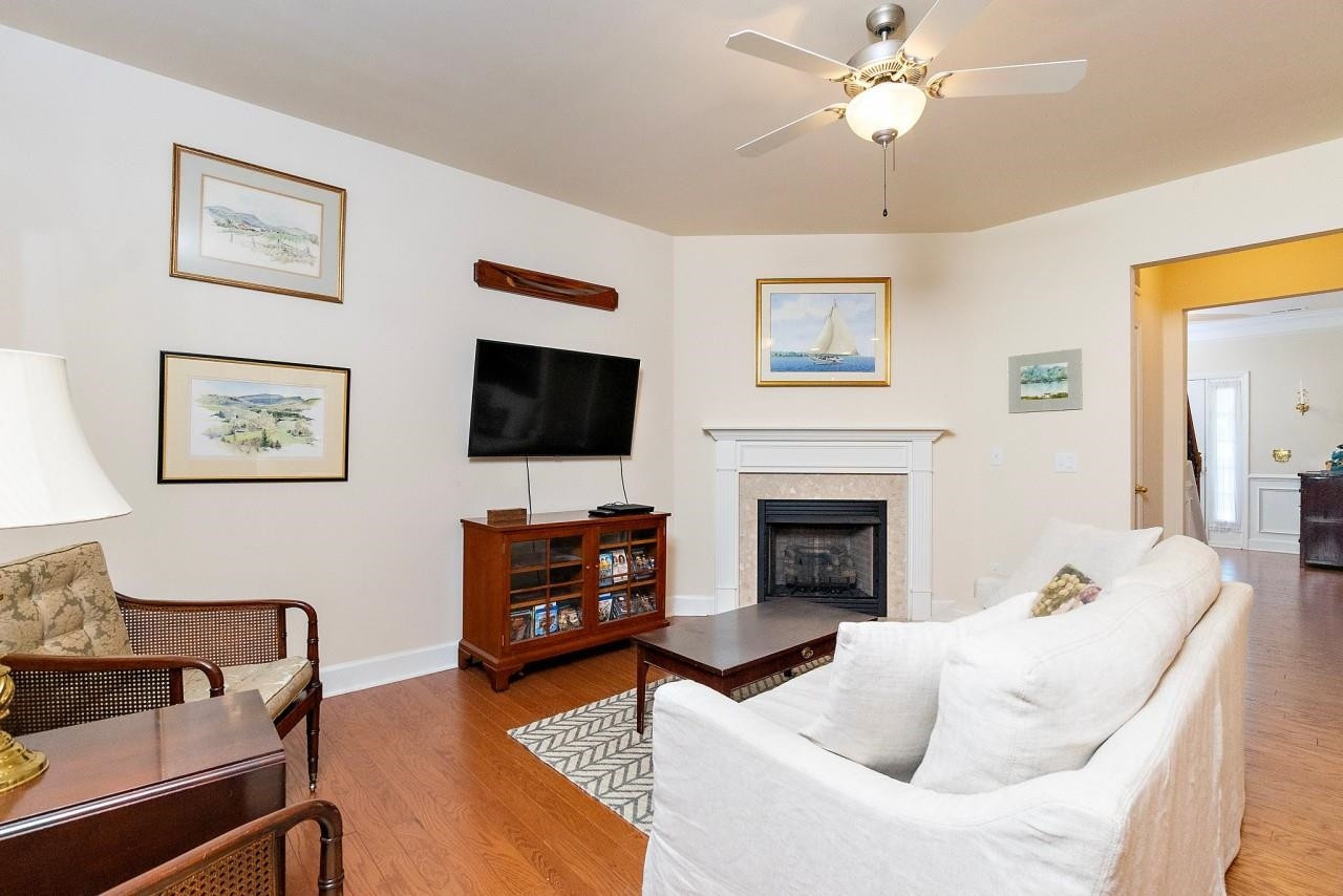 2033 Weston Green Loop Cary, NC 27513 - Photo 9 of 24 a living room with furniture a fireplace and a flat screen tv