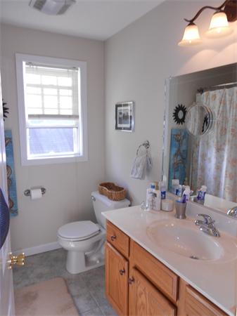 85 Dwight Road Springfield, MA 01108 - Photo 14 of 21 a bathroom with a granite countertop toilet a sink a mirror and a window