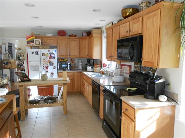 85 Dwight Road Springfield, MA 01108 - Photo 3 of 21 a kitchen with a stove top oven a sink a counter top space and cabinets