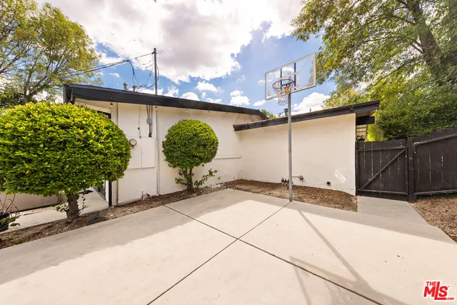 a swimming pool view with a couple of couches and a fire pit