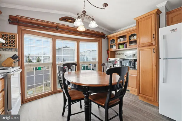 a dining room with furniture a chandelier and wooden floor