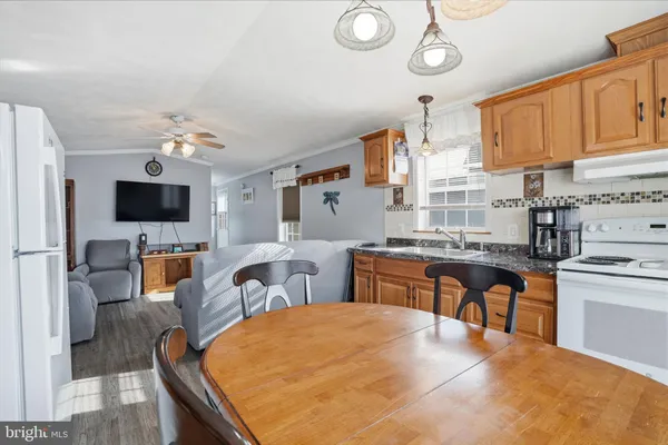 a kitchen with stainless steel appliances kitchen island granite countertop a sink and cabinets