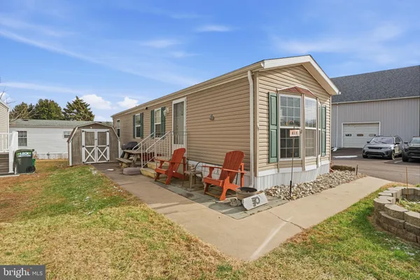 a view of a house with backyard porch and sitting area