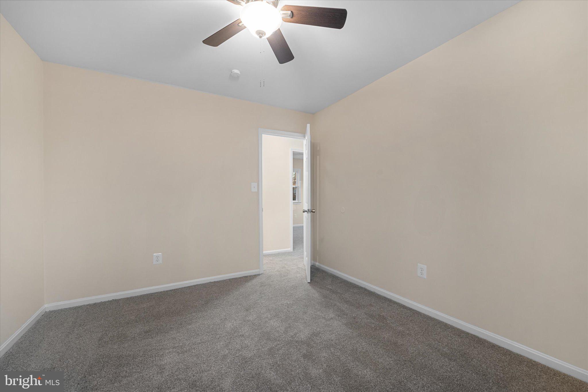 8016 Stillbrooke Road Manassas, VA 20112 - Photo 27 of 41 an empty room with a chandelier fan and windows