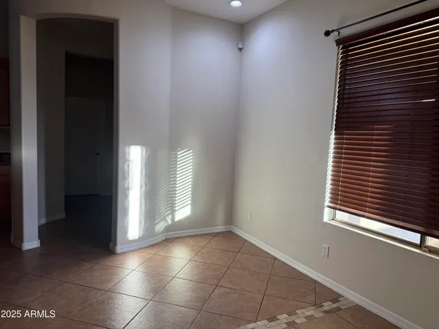 a view of an empty room and a window