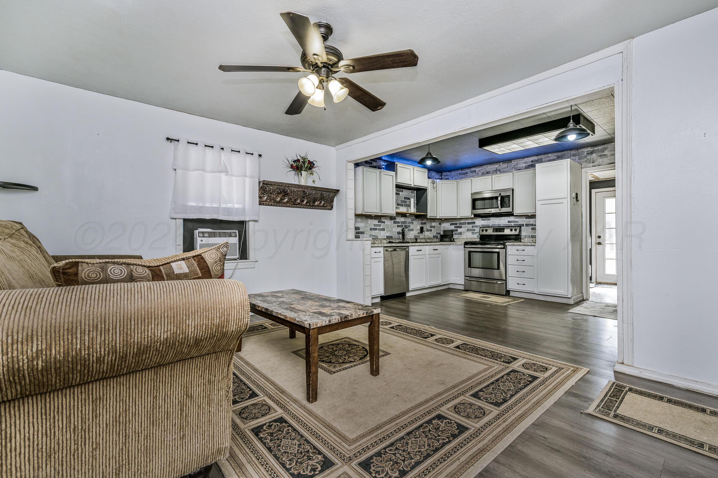4429 Bowie Street Amarillo, TX 79110 - Photo 5 of 20 a living room with stainless steel appliances furniture and a kitchen view