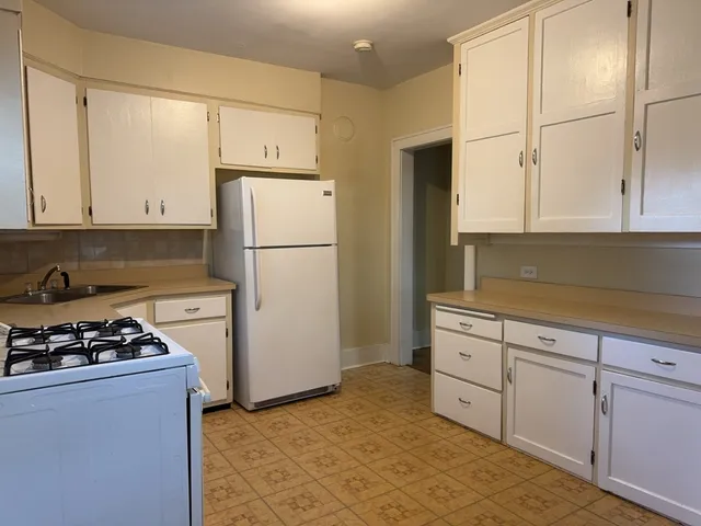 a kitchen with a refrigerator a stove a microwave and cabinets