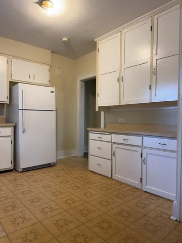 a kitchen with granite countertop cabinets and white appliances