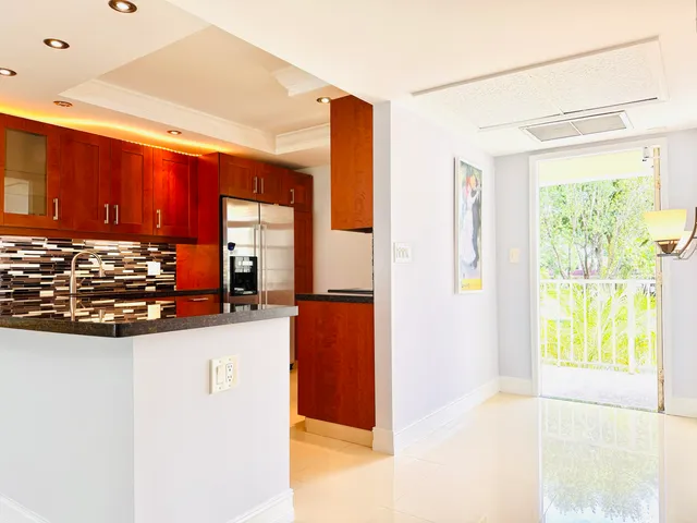 a kitchen with stainless steel appliances granite countertop a refrigerator and a stove