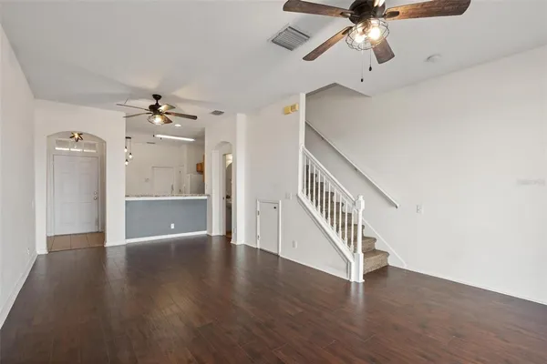 wooden floor in an empty room with a chandelier