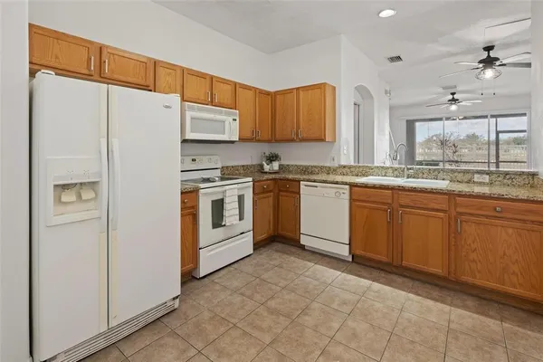 a kitchen with stainless steel appliances granite countertop a stove sink and refrigerator