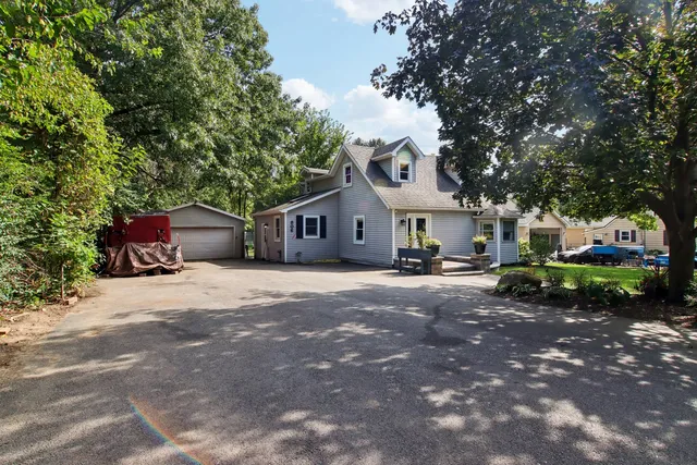 a view of a house with backyard and sitting area