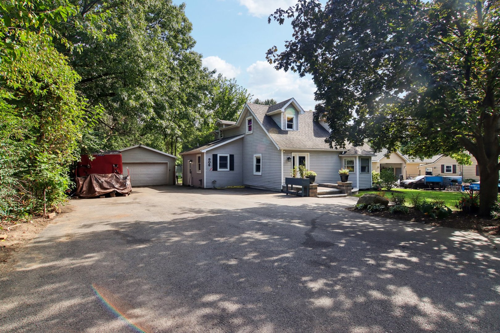 a view of a house with backyard and sitting area