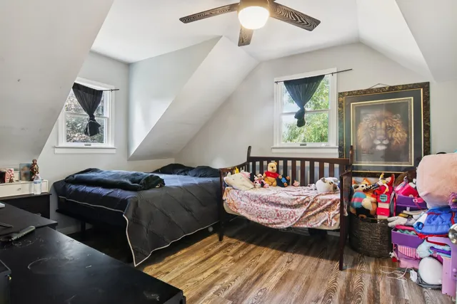 a bedroom with furniture and a flat screen tv