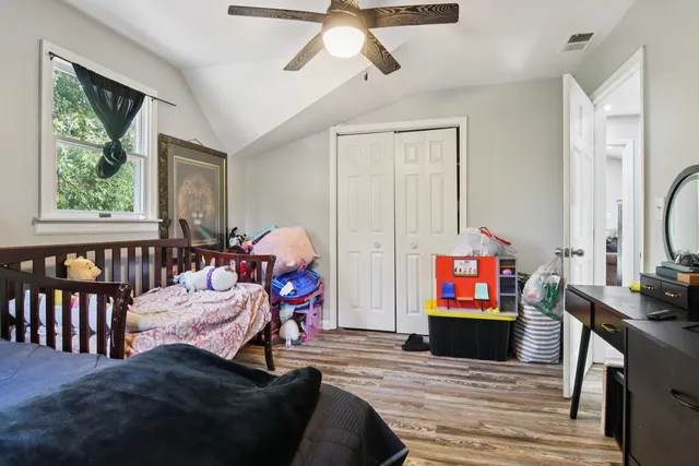 a living room with furniture and a ceiling fan