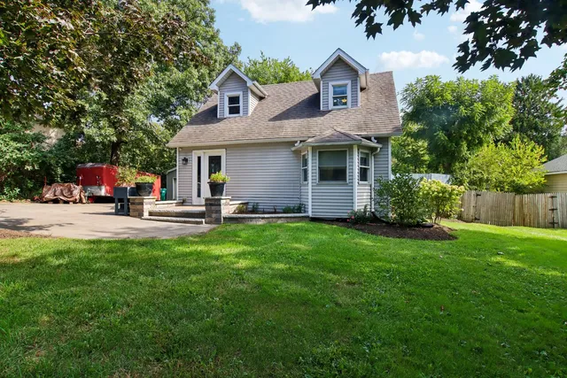 a view of a house with a yard and garage